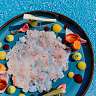 Shrimp tartare on plate with blue background